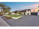 Charming single-story home showcasing a modern exterior, xeriscaping, and well-maintained landscaping at 5975 E Larkspur Dr, Scottsdale, AZ 85254
