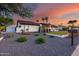 Well-maintained single-story home with landscaped yard, gravel ground cover and mature trees at 5975 E Larkspur Dr, Scottsdale, AZ 85254