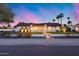 Inviting home exterior with a well-manicured lawn, paved walkway, and lush landscaping at 5975 E Larkspur Dr, Scottsdale, AZ 85254