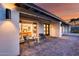 Inviting home exterior with a brick patio, outdoor seating, and views of the dining and living rooms at 5975 E Larkspur Dr, Scottsdale, AZ 85254