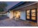 Stylish home exterior with a gray brick patio, comfortable seating, and clear views of the interior at 5975 E Larkspur Dr, Scottsdale, AZ 85254