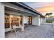 Stylish front porch featuring pavers, seating, and a modern front door at 5975 E Larkspur Dr, Scottsdale, AZ 85254