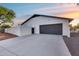 Clean two-car garage with a gray door and concrete driveway at 5975 E Larkspur Dr, Scottsdale, AZ 85254