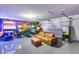 Finished garage with game machines, couch, and an epoxy-coated floor at 5975 E Larkspur Dr, Scottsdale, AZ 85254