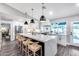 Spacious kitchen with a large center island, barstool seating, and modern stainless-steel appliances, perfect for entertaining at 5975 E Larkspur Dr, Scottsdale, AZ 85254