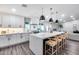 Open kitchen boasts island with seating, a modern vent hood, and recessed lighting at 5975 E Larkspur Dr, Scottsdale, AZ 85254