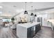 Open kitchen with modern island, stainless appliances, wet bar, and eat-in dining space at 5975 E Larkspur Dr, Scottsdale, AZ 85254