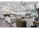 Spacious living room features a large sectional, fireplace, and a view of the kitchen at 5975 E Larkspur Dr, Scottsdale, AZ 85254
