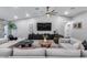 Comfortable living room with modern decor, plush seating, and a large television, creating a cozy and stylish entertainment space at 5975 E Larkspur Dr, Scottsdale, AZ 85254