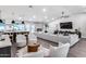 Bright living room featuring an elongated couch, decorative fireplace, and modern furnishings at 5975 E Larkspur Dr, Scottsdale, AZ 85254