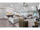 Spacious living room with modern furniture, fireplace and easy access to the adjacent kitchen at 5975 E Larkspur Dr, Scottsdale, AZ 85254