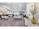 Bright, open-concept living space featuring modern furniture, a fireplace, and hardwood floors at 5975 E Larkspur Dr, Scottsdale, AZ 85254