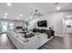 Comfortable living room featuring vaulted ceiling, modern furniture, fireplace, and sleek, dark entertainment center at 5975 E Larkspur Dr, Scottsdale, AZ 85254