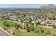 Expansive aerial shot of a community nestled on a golf course with mountain views and abundant green space at 6009 N 79Th St, Scottsdale, AZ 85250