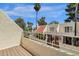Balcony view of red tile roofs, palm trees, and light stucco walls in the community at 6009 N 79Th St, Scottsdale, AZ 85250
