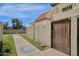 Exterior view of stucco walls, red tile roof, and a wooden gate to the back patio at 6009 N 79Th St, Scottsdale, AZ 85250