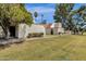 Well-maintained front yard with grass, green trees, and stucco walls surrounding the house at 6009 N 79Th St, Scottsdale, AZ 85250