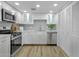 Modern kitchen features white cabinetry, patterned backsplash, and stainless appliances at 6009 N 79Th St, Scottsdale, AZ 85250
