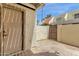 Enclosed back patio area with stucco walls, a gate, and an access door to the home at 6009 N 79Th St, Scottsdale, AZ 85250