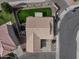 Overhead view of a home with a tile roof, green lawn, playground, trampoline, and fenced backyard at 6228 S Nash Way, Chandler, AZ 85249