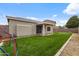 Green backyard featuring a covered patio, lawn, and playground, perfect for outdoor activities at 6228 S Nash Way, Chandler, AZ 85249