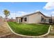Lush green backyard with a covered patio, trampoline, and playground, ideal for Gathering fun and relaxation at 6228 S Nash Way, Chandler, AZ 85249
