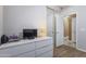 Bright bedroom with a closet, doorway, wood floors, and white dresser, offering a serene living space at 6228 S Nash Way, Chandler, AZ 85249