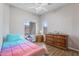 Bright bedroom with ample natural light, featuring wood-look flooring and a large dresser at 6228 S Nash Way, Chandler, AZ 85249