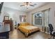 Well lit bedroom with wood flooring, large window, and decorated with pictures at 6228 S Nash Way, Chandler, AZ 85249
