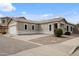 Single-story home featuring an attached garage, desert landscaping, and a neutral colored facade at 6228 S Nash Way, Chandler, AZ 85249