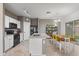 Bright kitchen features sleek countertops, white cabinetry, and an adjacent dining area at 6228 S Nash Way, Chandler, AZ 85249
