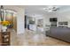Open-concept floor plan combining the living room and kitchen with tiled floors and modern design at 6228 S Nash Way, Chandler, AZ 85249