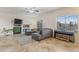 Comfortable living room featuring neutral colors, a ceiling fan, and access to other rooms at 6228 S Nash Way, Chandler, AZ 85249
