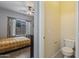 View of the bedroom with an ensuite bathroom, a window, ceiling fan, and hardwood flooring at 6228 S Nash Way, Chandler, AZ 85249