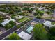 Sunset aerial view captures a community and home's pool, sports court, and mature landscaping for serene living at 6301 N 16Th Dr, Phoenix, AZ 85015