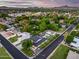 Drone shot of neighborhood showcasing lush landscaping, pool, and panoramic views of mountains in the distance at 6301 N 16Th Dr, Phoenix, AZ 85015