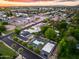 Charming home with a backyard featuring a pool, sports court, and desert landscaping under a vibrant sunset sky at 6301 N 16Th Dr, Phoenix, AZ 85015