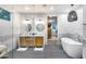 Elegant bathroom with double vanity, marble accents, glass shower, and soaking tub at 6301 N 16Th Dr, Phoenix, AZ 85015