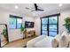 Bright bedroom with modern decor, a large TV, wood floors and a glass patio door with backyard views at 6301 N 16Th Dr, Phoenix, AZ 85015