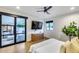 Bright bedroom with black trim windows and doors that provide views of the landscaped backyard and grill area at 6301 N 16Th Dr, Phoenix, AZ 85015