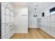Spacious walk-in closet with ample shelving, hanging space, and hardwood floors at 6301 N 16Th Dr, Phoenix, AZ 85015