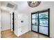 Modern entryway featuring a pendant light, wood floors, and a glass door leading to the outside at 6301 N 16Th Dr, Phoenix, AZ 85015