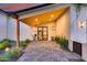 Stylish front entrance with wood ceiling, modern door, pavers, and manicured landscaping at 6301 N 16Th Dr, Phoenix, AZ 85015