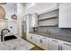 Bright kitchen featuring stainless steel appliances, gray countertops, hardwood floors, and white cabinets at 6301 N 16Th Dr, Phoenix, AZ 85015