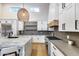 Bright kitchen featuring stainless steel appliances, gray countertops, hardwood floors, and marble island at 6301 N 16Th Dr, Phoenix, AZ 85015