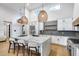 Bright kitchen featuring stainless steel appliances, gray countertops, hardwood floors, and marble island at 6301 N 16Th Dr, Phoenix, AZ 85015
