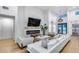 Bright and airy living room featuring a fireplace, modern decor, and hardwood floors at 6301 N 16Th Dr, Phoenix, AZ 85015