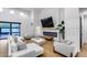 Contemporary living room featuring a fireplace, hardwood floors, and sleek modern furniture at 6301 N 16Th Dr, Phoenix, AZ 85015