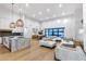 Open-concept living space with a modern kitchen, dining area, and comfortable seating area at 6301 N 16Th Dr, Phoenix, AZ 85015