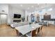 Open-concept living area with high ceilings, modern fireplace, dining space, and seamless flow to the kitchen at 6301 N 16Th Dr, Phoenix, AZ 85015